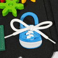 Blue shoe with white laces inside the Montessori Dino Busy Board