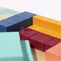 Close up of blue, yellow, red, and turquoise Tetris wooden blocks. 