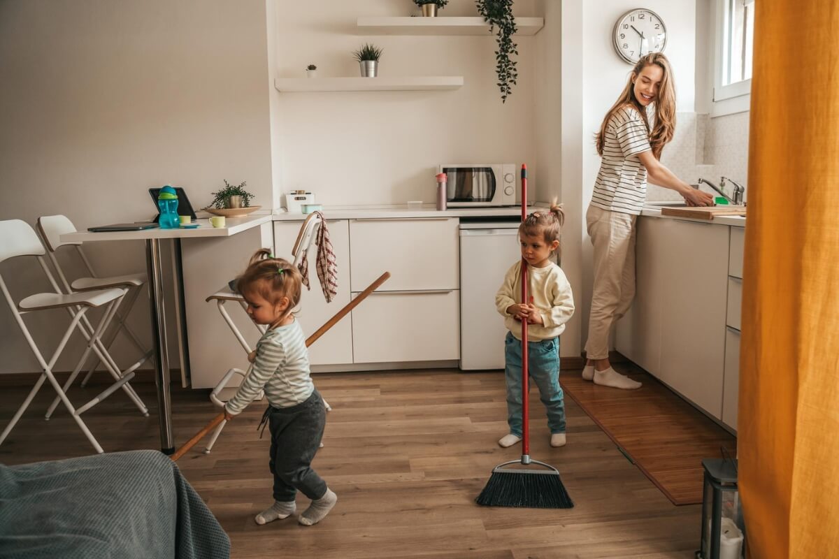Two siblings helping their mom with cleaning the house. 