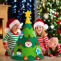 Three little children sitting next to a 360 Montessori Christmas Tree.