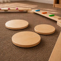 Wooden balance beams and platforms on a carpeted floor.