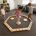 Children playing with Montessori Balance Beams and Stones.