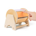 A finger touching a colorful spinning Montessori toy.
