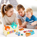 Parents and toddler playing together with a Montessori High Five Math toy that uses felt hands, number blocks, and math cards.