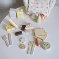 Close up on all wooden pieces of the Montessori Picnic Set.