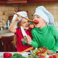 Two kids using Montessori Cooking tools to prepare a salad and enjoying the taste.