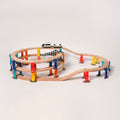 Large multilevel wooden train track set with colorful support pillars and a magnetic toy train traveling on the upper level.