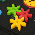 Colorful gears for fine motor skills inside of the Montessori Dino Busy Board