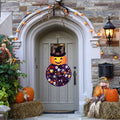Montessori Halloween Pumpkin shown hanging on the front door as a Halloween decoration.