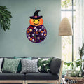 Montessori toy in a shape of a pumpkin hanged on the wall of the green living room.