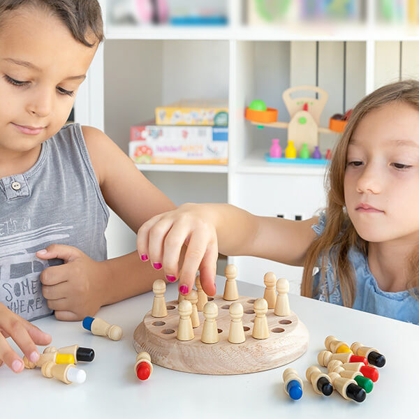 A boy and a girl playing the Montessori Memory match