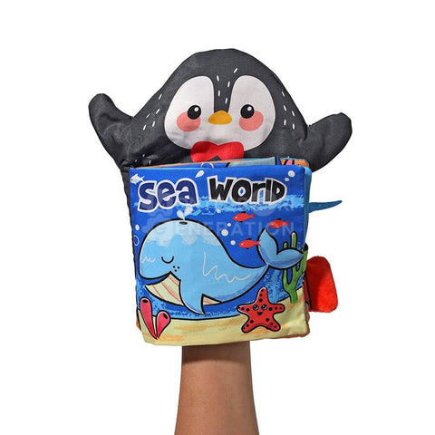Penguin Montessori cloth book fitted on a hand as a puppet.