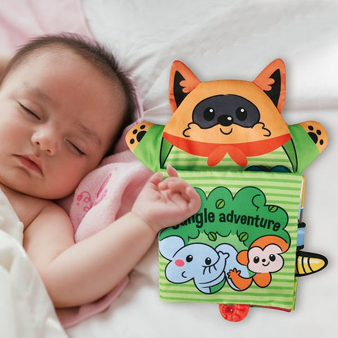 A baby lying next to a Montessori Baby Cloth Book. 