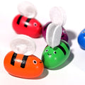 Red, purple, blue, green, and orange bee toys from a Montessori Generation's Bee Box set.