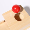 Part of the Montessori Object Permanence Box and a ball as seen from above.