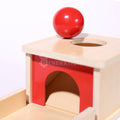 Close-up of the Object Permanence Box and red ball on it.