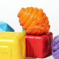 Orange, yellow, and red pieces of the Montessori Shape Blocks set.