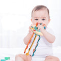 A baby chewing on a silicone Montessori toy made for infants.