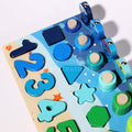 Blue numbers, shapes, rings, and fish that are part of the Montessori Smart Board set.
