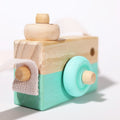 Close-up of a turquoise Montessori Wooden Camera.