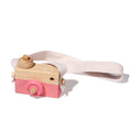 Pink wooden camera toy for children.