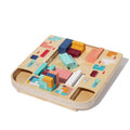 Colorful wooden pieces placed around the Montessori Wooden Tetris board.